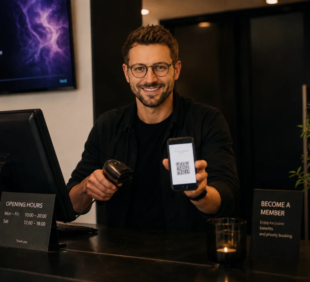 A host at the box office holding up a ticket on a phone